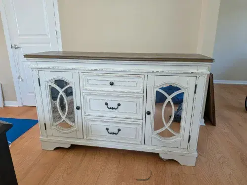 White vintage buffet cabinet with glass doors and wooden top