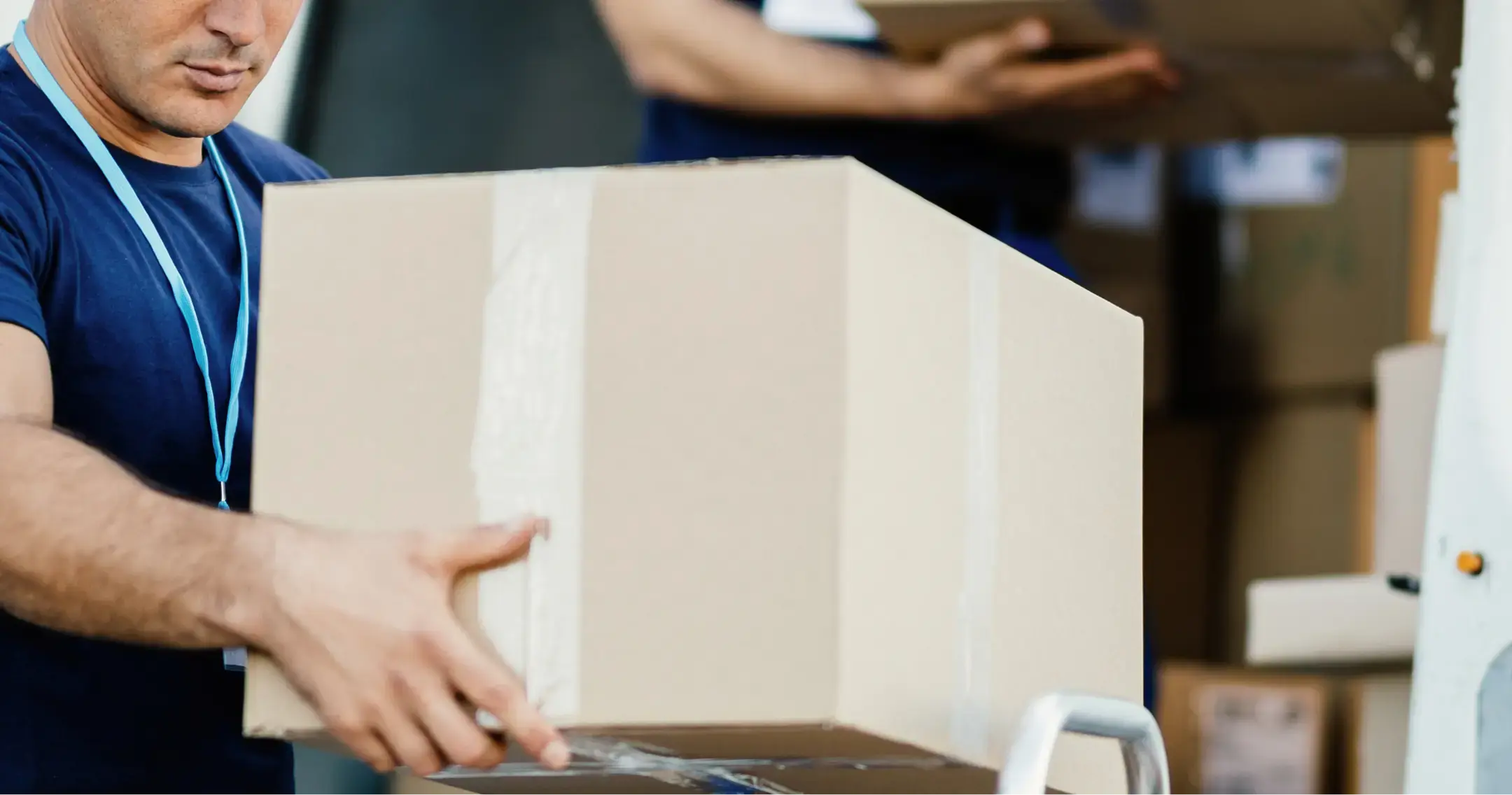 Professional mover holding a moving box, ready for relocation