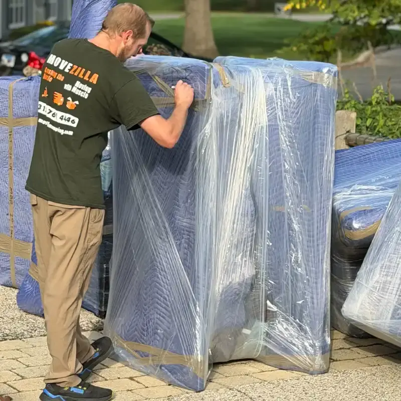 Professional movers packing boxes and furniture